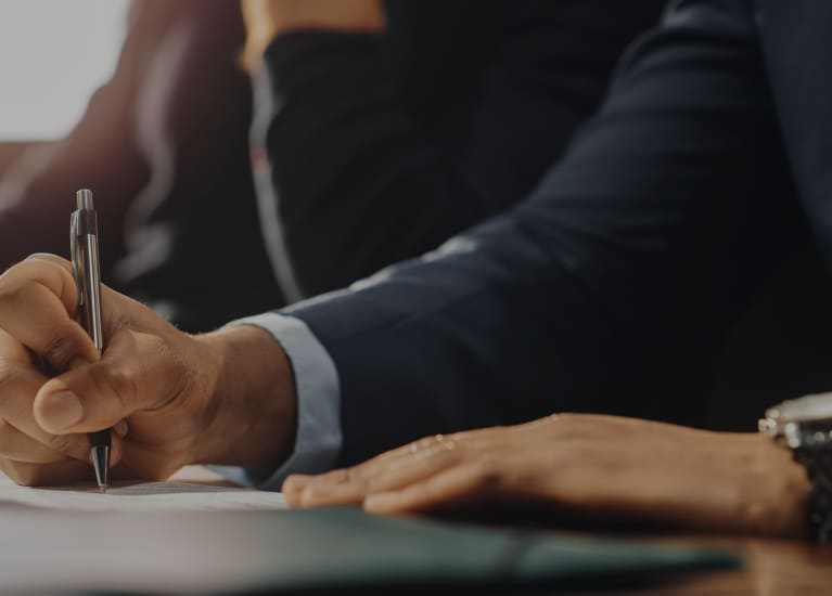 A person writing on a piece of paper