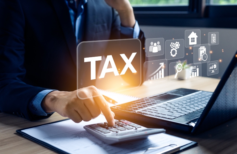 Businessman calculating annual taxes and paying taxes