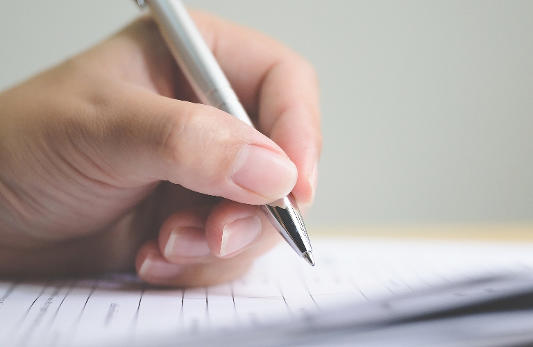 Hand of man signing documents