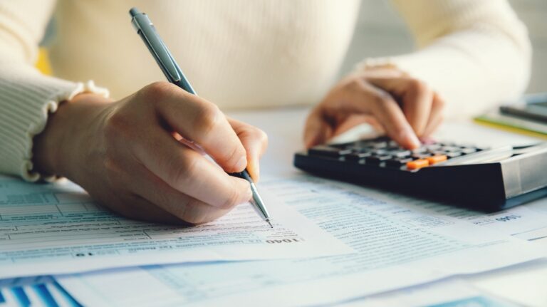 woman fills out tax forms