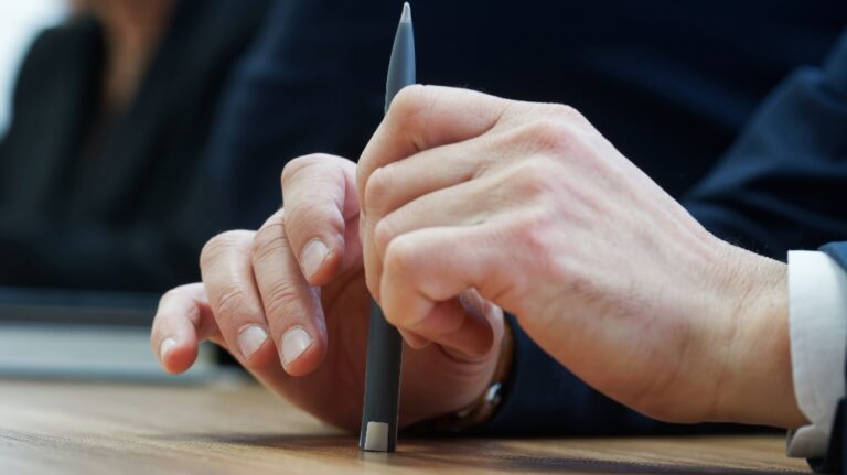 A man holds a fountain pen