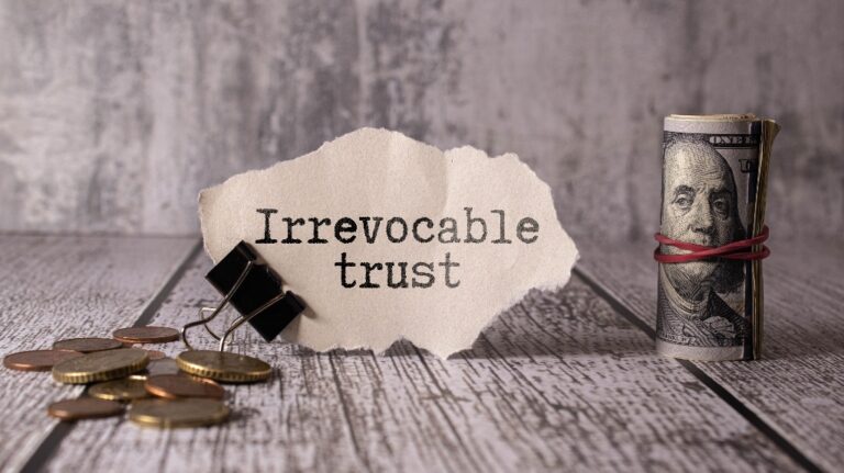 Irrevocable trust text on white sticker and pen