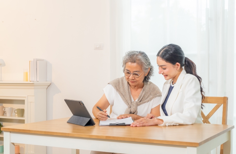 Happy Asian senior retired woman sign contract