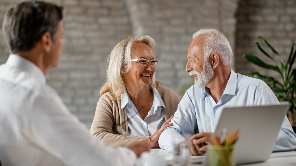 Happy mature couple communicating while having consultations